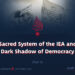 The Sacred System of the IEA and the Dark Shadow of Democracy